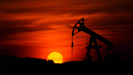 silhouette of an oil rig at sunset; image used for blog post promoting TXCPA Houston Energy Conference on August 26, 2021