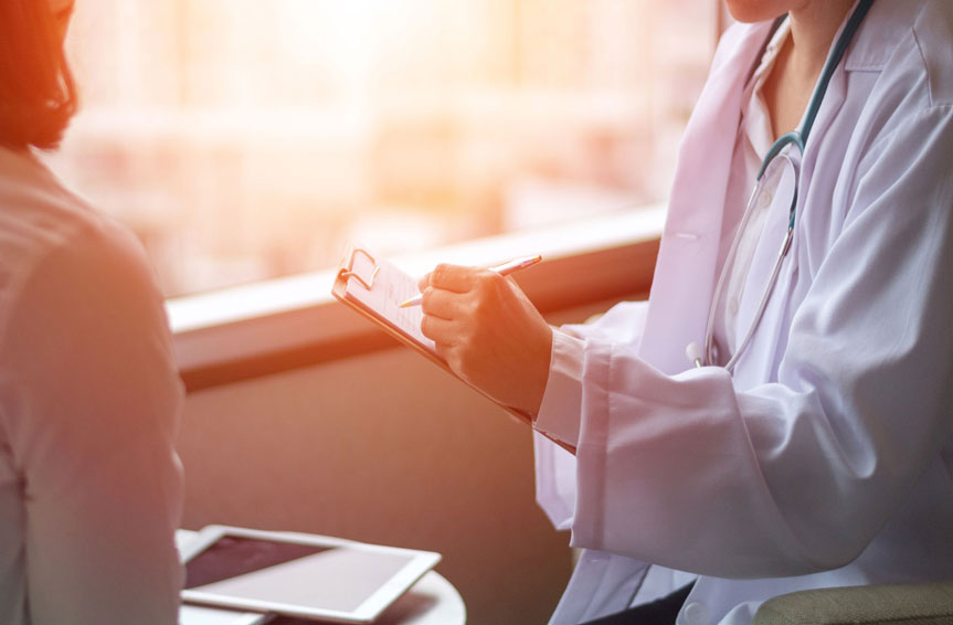 doctor writing on a clipboard