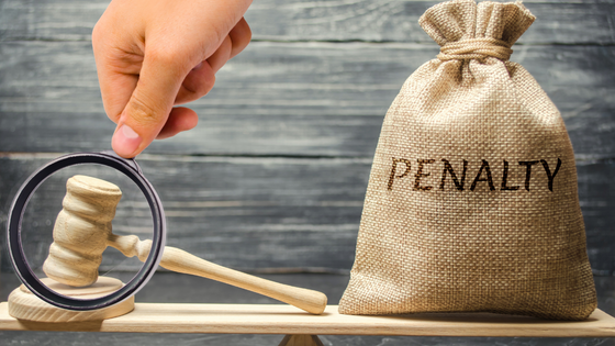 020123 – Retirement Plan Early Withdrawals – What to Know – 560×315 An image of a gavel and bag labelled "penalty" sitting on a wooden plank; for blog post about retirement plan early withdrawal penalties