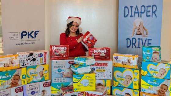 A photo of PKF Texas International Tax Director Nikki Homratsamy posing for a charity diaper drive; for blog post celebrating Women's History Month