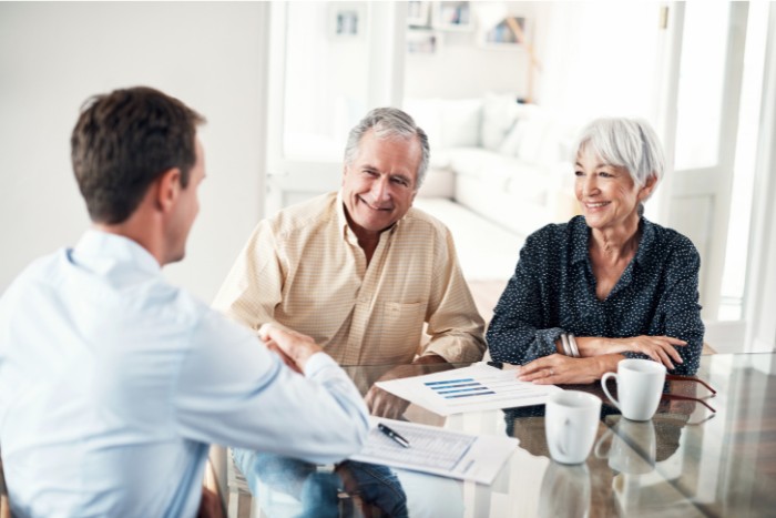 Senior couple discussing IRA withdrawal strategies with a financial advisor