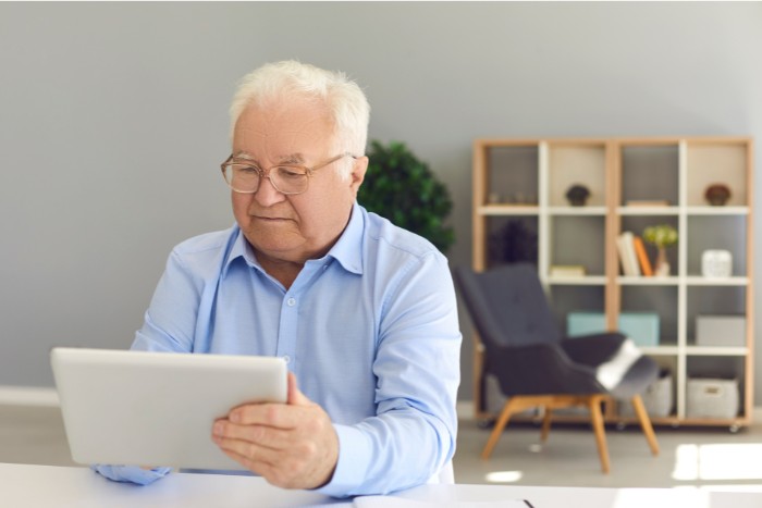 Retiree reviewing IRA withdrawal rules on a tablet